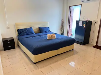 a bedroom with a bed with blue sheets and blue pillows at AB House in Kathu