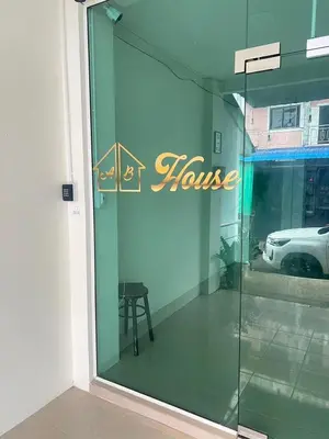 a glass door with a sign that reads house at AB House in Kathu