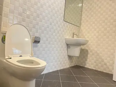 a bathroom with a toilet and a sink at AB House in Kathu