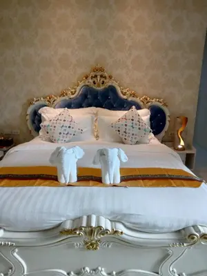 a bedroom with a bed with stuffed elephants on it at Lucky Villa Kamala in Kamala Beach