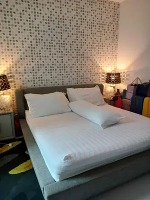 a bed with white sheets and pillows in a room at Lucky Villa Kamala in Kamala Beach