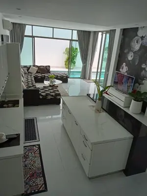 a living room with a table and a couch at Lucky Villa Kamala in Kamala Beach
