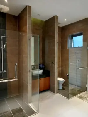 a bathroom with a glass shower and a toilet at Lucky Villa Kamala in Kamala Beach