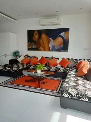 a living room with two couches and a table at Lucky Villa Kamala in Kamala Beach