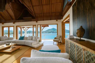 a living room with white furniture and a view of the ocean at Villa Nevaeh - Ocean Front Private Villa Kamala Beach in Phuket Town
