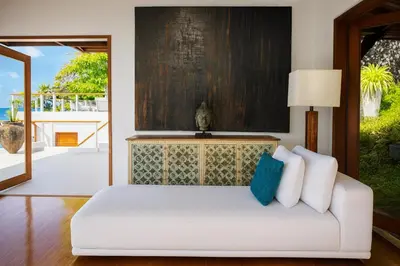 a living room with a white couch in front of a door at Villa Nevaeh - Ocean Front Private Villa Kamala Beach in Phuket Town
