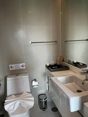 a bathroom with a toilet and a sink at Aristo Resort Surin Beach M18 in Phuket Town
