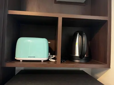 a microwave and a toaster sitting on a shelf at Aristo Resort Surin Beach M18 in Phuket Town
