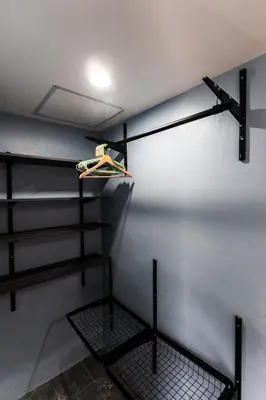 a room with black shelves and a white wall at Apollo Hotel Chalong in Ban Suan