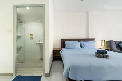 a bedroom with a bed and a glass shower at Kamala - Holiday Home - Studio Pool Access Bungalow in Kamala Beach