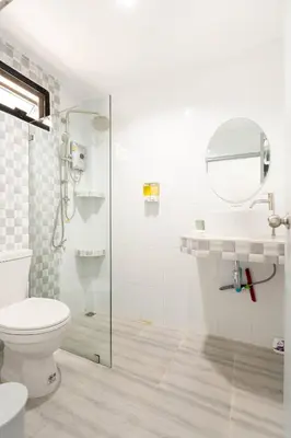 a white bathroom with a toilet and a shower at Kamala - Holiday Home - Studio Pool Access Bungalow in Kamala Beach