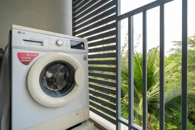 a washing machine sitting on a balcony at The Title Residencies Nai Yang - 1 Bedroom Apartment in Nai Yang Beach