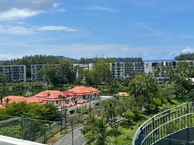 arial view of a resort with a bridge and buildings at Apartments in Skypark Laguna Bang Tao in Bang Tao Beach