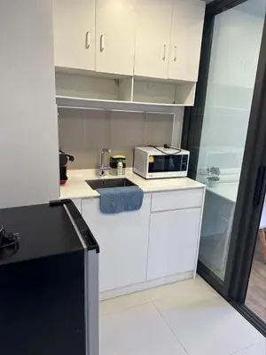 a kitchen with a sink and a microwave at Apartments in Skypark Laguna Bang Tao in Bang Tao Beach