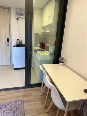 a kitchen with a table and chairs and a refrigerator at Apartments in Skypark Laguna Bang Tao in Bang Tao Beach