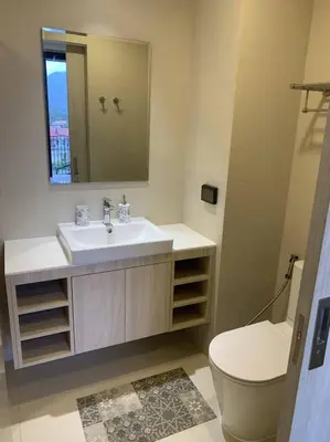 a bathroom with a sink and a toilet and a mirror at Apartments in Skypark Laguna Bang Tao in Bang Tao Beach