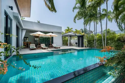 a swimming pool in front of a villa at Ban Bua Lux x MonthStayz Thailand in Rawai Beach