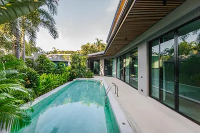 an indoor swimming pool in the backyard of a house at Ban Bua Lux x MonthStayz Thailand in Rawai Beach