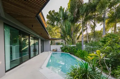 an indoor swimming pool in the backyard of a house at Ban Bua Lux x MonthStayz Thailand in Rawai Beach