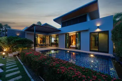 a house with a swimming pool in front of it at Ban Bua Lux x MonthStayz Thailand in Rawai Beach