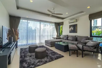 a living room with a couch and a tv at Phuket villa in Laguna Park in Bang Tao Beach