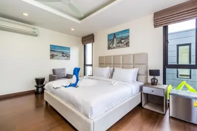 a bedroom with a bed with a blue dinosaur on it at Phuket villa in Laguna Park in Bang Tao Beach