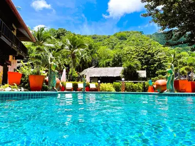 a swimming pool in front of a resort at Boomerang Village Resort Kata in Kata Beach