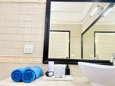 a bathroom with a sink and a mirror at Boomerang Village Resort Kata in Kata Beach