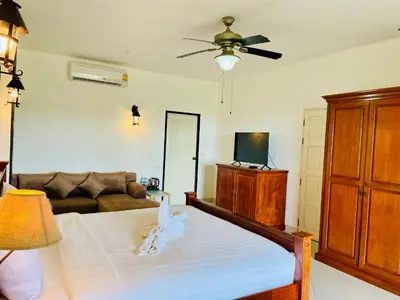 a living room with a bed and a couch at Boomerang Village Resort Kata in Kata Beach
