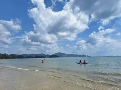 a group of people in the water on a beach at PAN Beachfront Resort Krabi in Klong Muang Beach