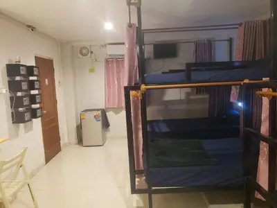 a dorm room with a bunk bed and a doorway at Lucky Guest House in Phi Phi Don