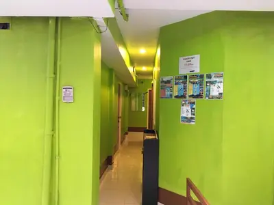 a hallway with green walls in a hospital at Lucky Guest House in Phi Phi Don