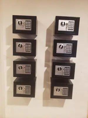 a group of three microwaves on a wall at Lucky Guest House in Phi Phi Don