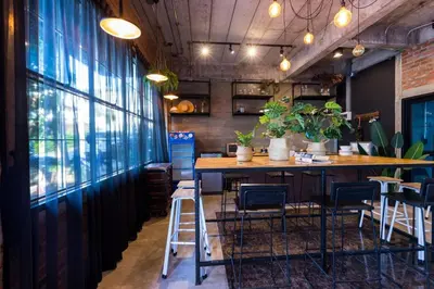 a bar in a restaurant with chairs and a table at 9BR Neverland Loft Pool Villa in Ban Saiyuan (1)