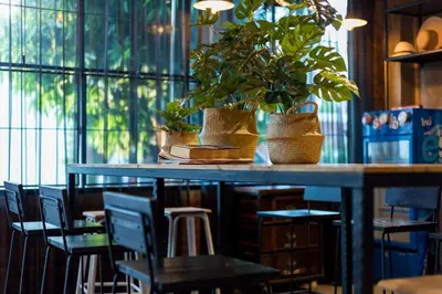 a table with chairs and potted plants on it at 9BR Neverland Loft Pool Villa in Ban Saiyuan (1)