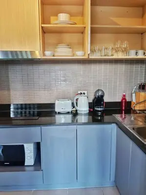 a kitchen with white cabinets and a counter top at Hill Myna Condo by Bcare - Two Bedrooms in Ban Thalat Choeng Thale