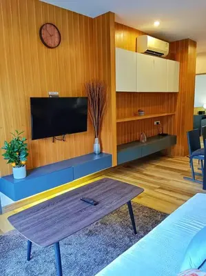 a living room with a tv on a wooden wall at Hill Myna Condo by Bcare - Two Bedrooms in Ban Thalat Choeng Thale