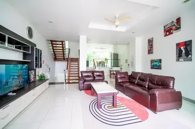 a living room with a couch and a table at patong villa2：四卧泳池别墅/两个海景房/近班赞酒吧街 in Patong Beach