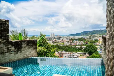 a swimming pool with a view of a city at patong villa2：四卧泳池别墅/两个海景房/近班赞酒吧街 in Patong Beach