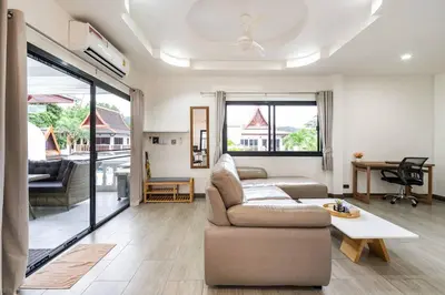 a living room with a couch and a table at Kamala - 2 BR Pool View Apartment in Kamala Beach