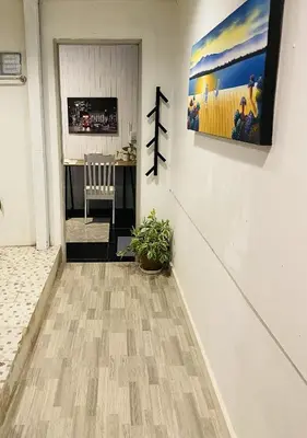 a hallway with a table and a painting on the wall at Malai Maikhao Near Beach in Ban Mai Salae
