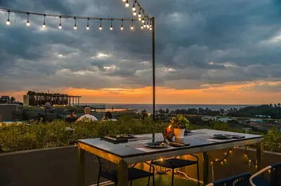 a table on a rooftop with a view of the ocean at Luxury sea view apartment at Mida Grande Surin in Surin Beach
