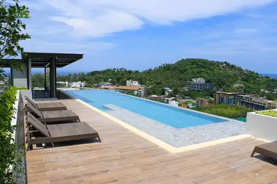 a swimming pool on the roof of a building at Luxury sea view apartment at Mida Grande Surin in Surin Beach