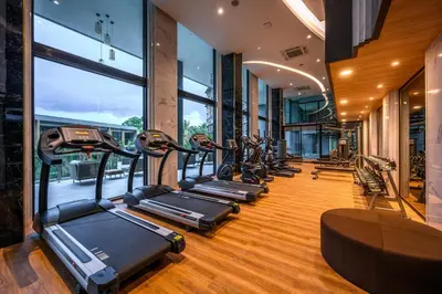 a row of treadmills in a gym with windows at Luxury sea view apartment at Mida Grande Surin in Surin Beach