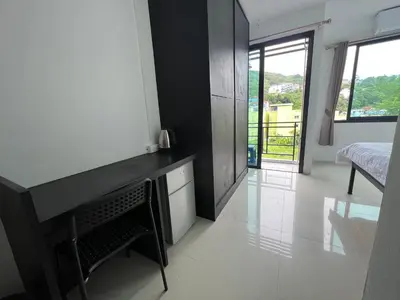 a room with a desk and a bedroom with a bed at Patong Easy Life 6 in Patong Beach