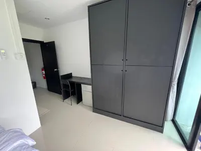 a large gray cabinet in a room with a desk at Patong Easy Life 6 in Patong Beach
