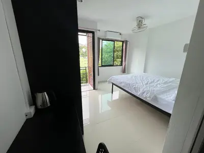 a bedroom with a bed and a window at Patong Easy Life 6 in Patong Beach