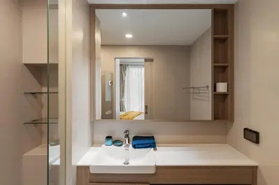 a bathroom with a sink and a mirror at 2 br Terrace Laguna, SkyPark in Thalang