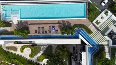 an overhead view of a swimming pool next to a house at 2 br Terrace Laguna, SkyPark in Thalang