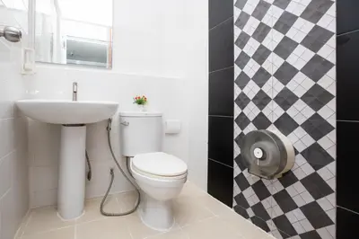 a bathroom with a toilet and a sink at Bell Lifestyle Hostel Phuket in Nai Yang Beach